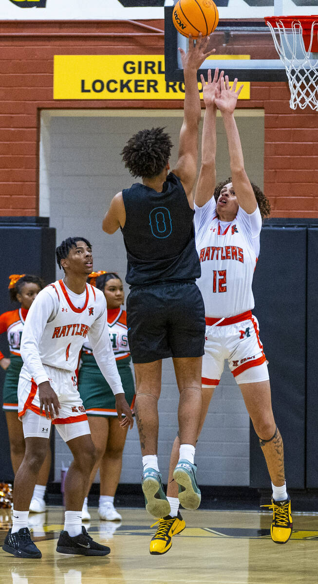 Mojave guard Zacarrion Jackson (1) shoots over Mojave forward Devin Thomas (12) during the firs ...