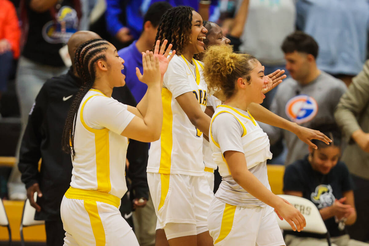 Democracy Prep players celebrate winning a Class 5A girls basketball state semifinal game betwe ...