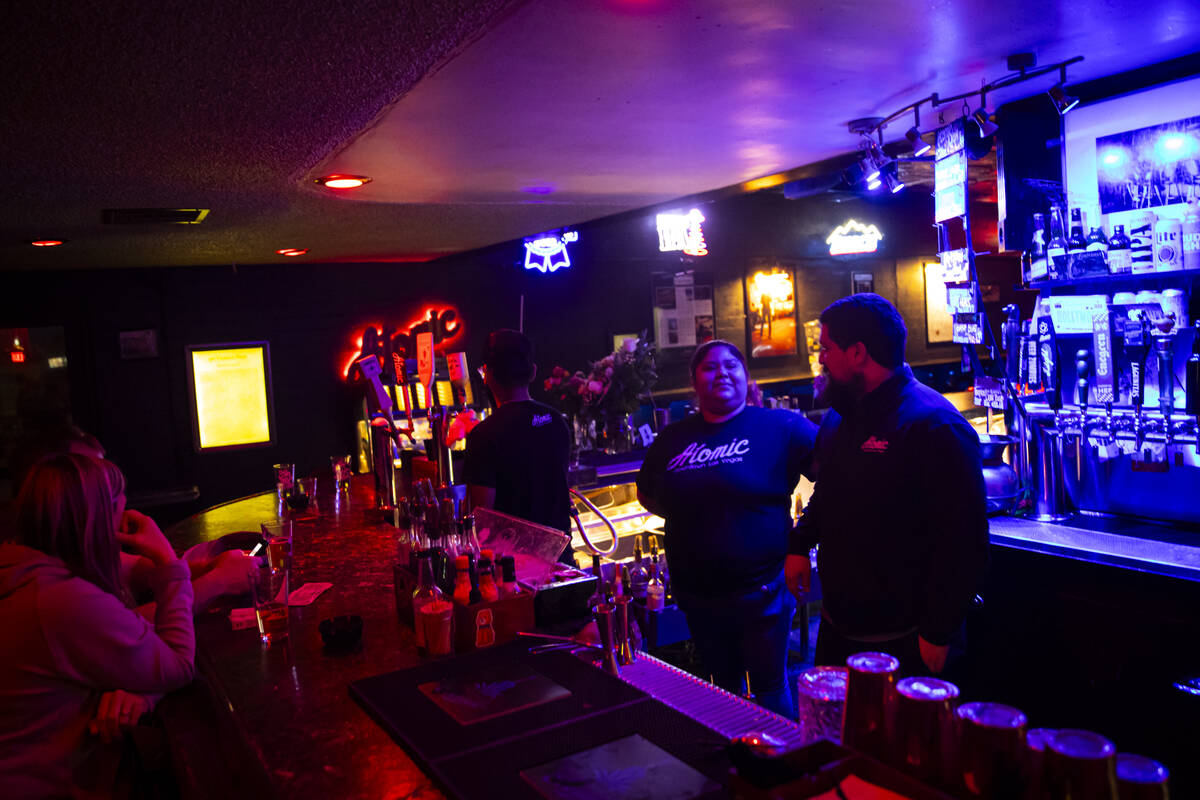 Maria Ledesma, kitchen manager, center, and general manager Andrew Mendez talk at Atomic Liquor ...