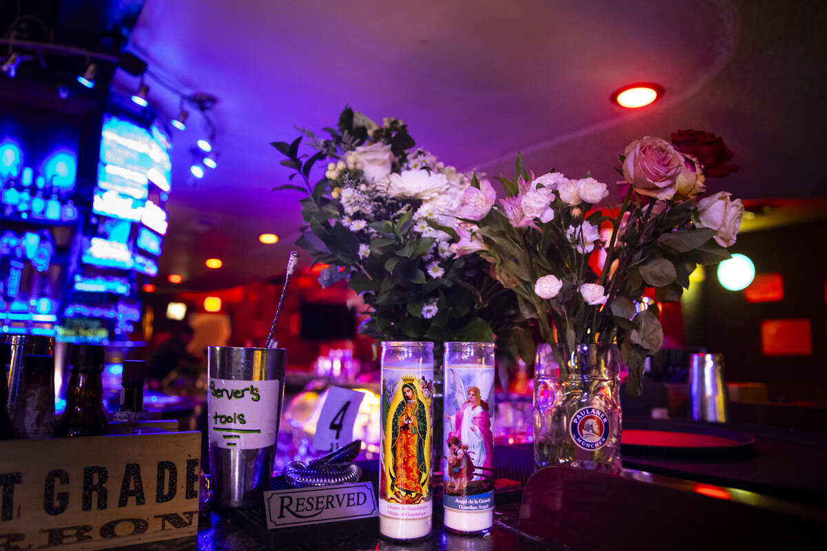 Floral arrangements and candles from nearby businesses that were left in memory of Hope Ritter, ...