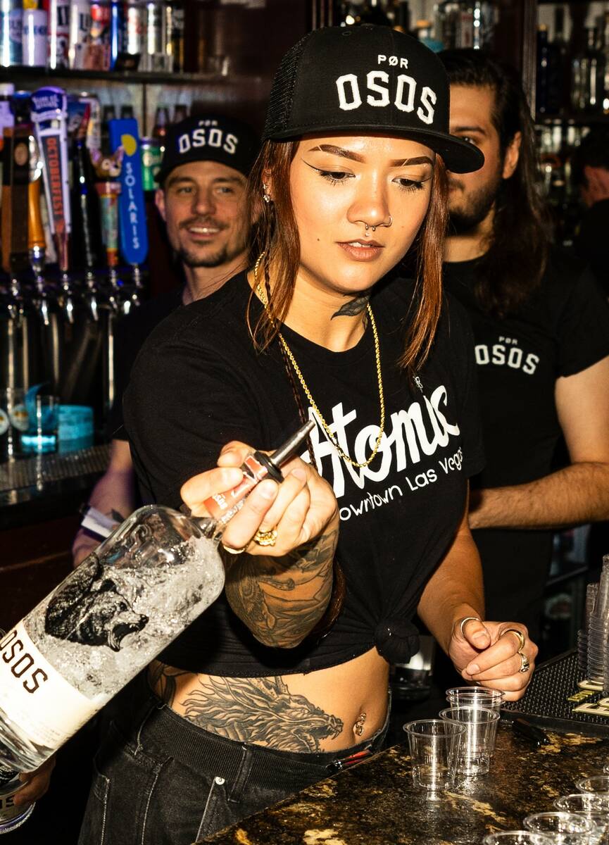 Hope Ritter is seen behind the bar in this photo provided by Atomic Liquors.