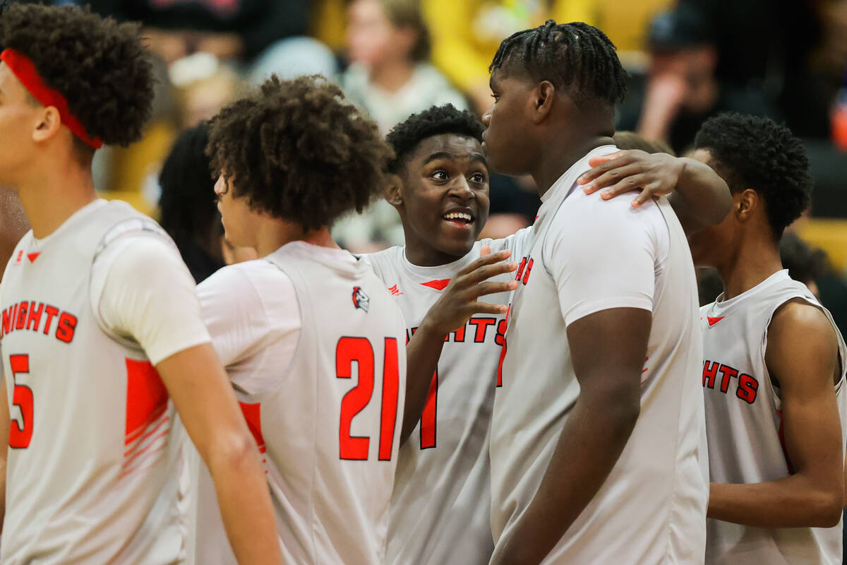 Mater East guard Markus Burton (1) walks off the court with his teammates after winning a class ...