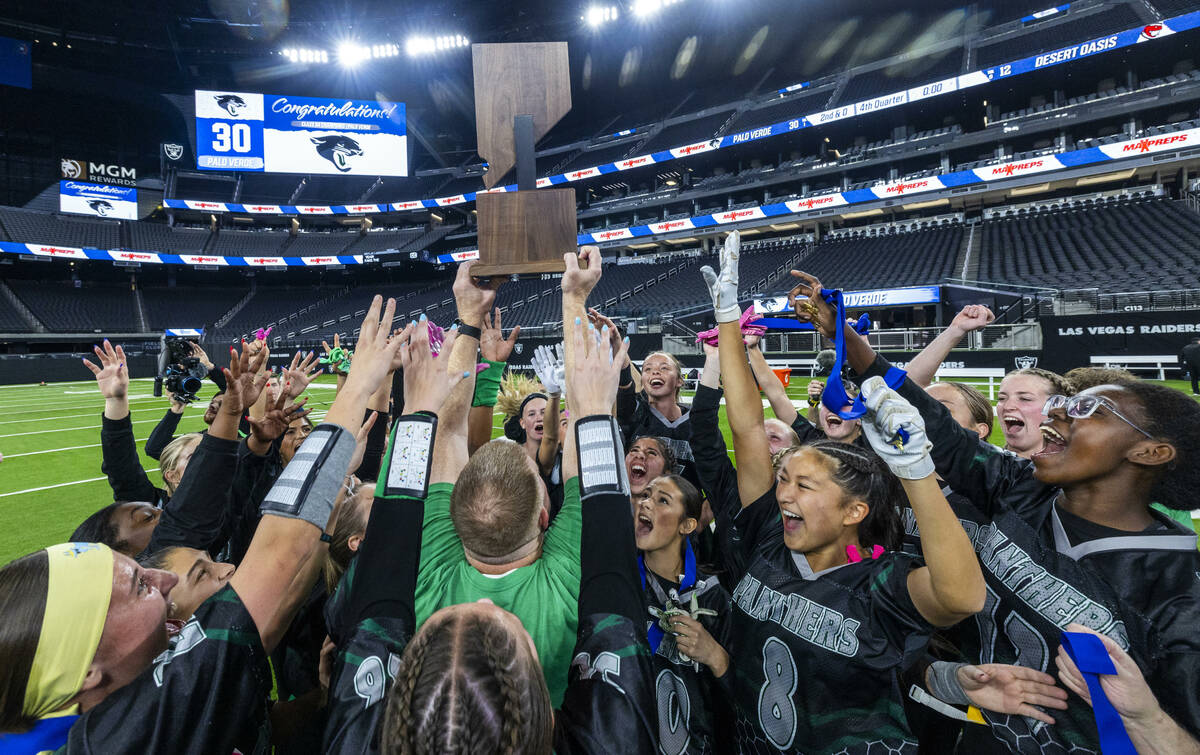 Palo Verde head coach Rick Eurich holds up the winning trophy with teammates after their 5A fla ...