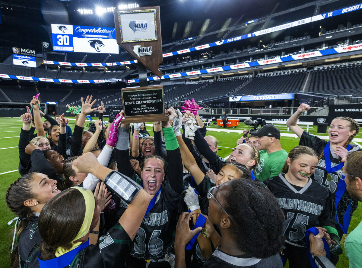 Palo Verde linebacker Madeline West (36) holds up the winning trophy with teammates after their ...
