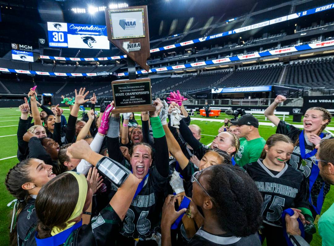 Palo Verde linebacker Madeline West (36) holds up the winning trophy with teammates after their ...
