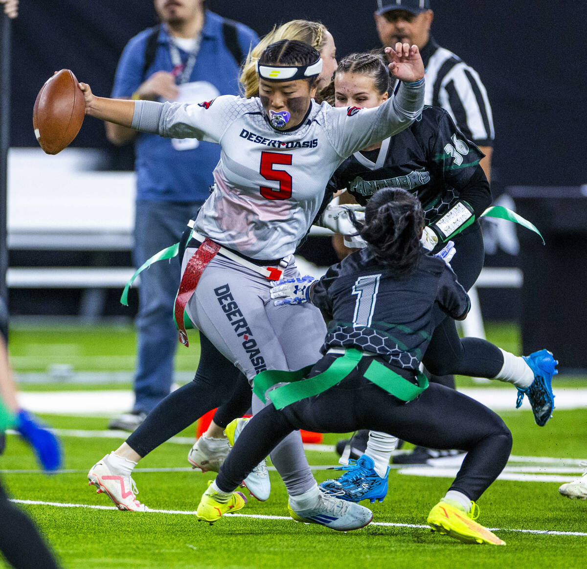Desert Oasis quarterback Akemi Higa (5) looks to evade a flag pull by Palo Verde linebacker Mak ...