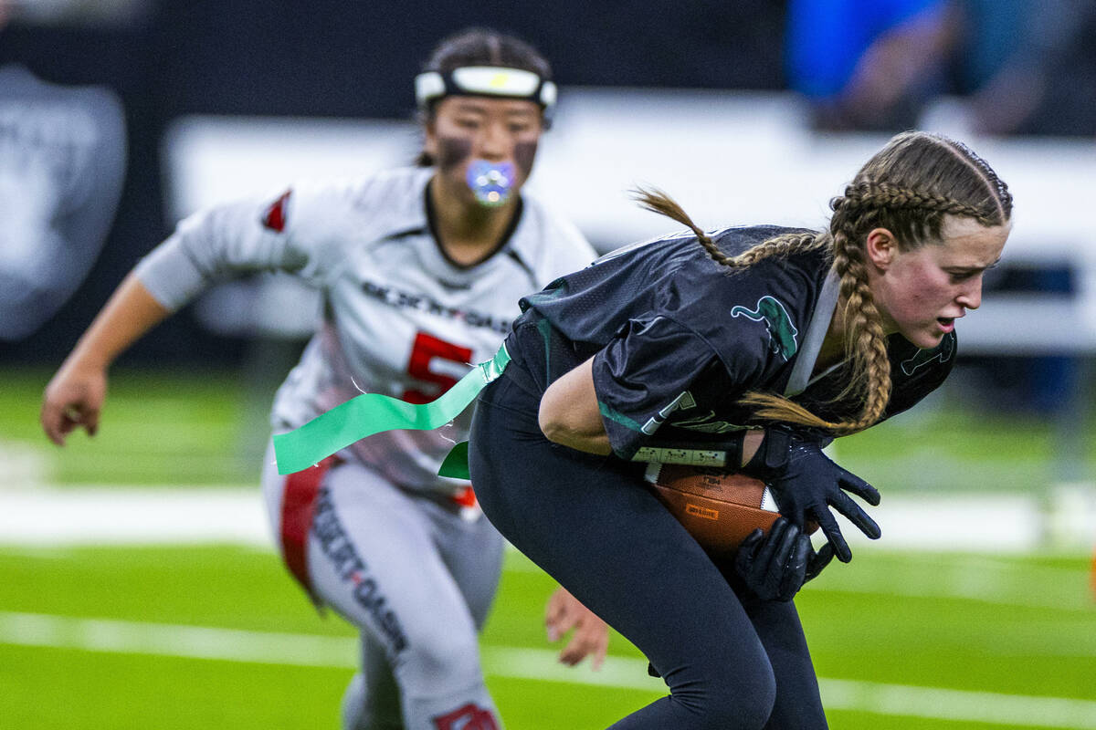 Palo Verde wide receiver Ruth Robison (55) secures a catch as Desert Oasis defensive back Akemi ...