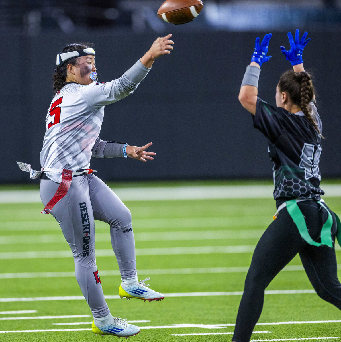 Desert Oasis quarterback Akemi Higa (5) gets off a pass over Palo Verde during the first half o ...