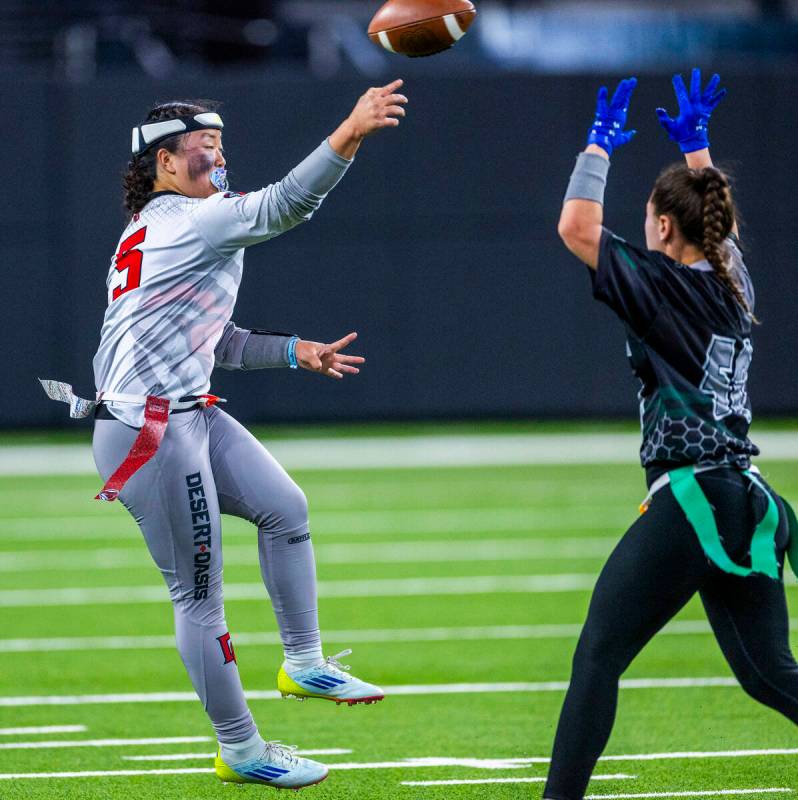 Desert Oasis quarterback Akemi Higa (5) gets off a pass over Palo Verde during the first half o ...