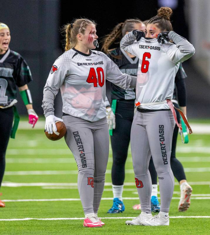 Desert Oasis wide receiver Brooke Campion (6) is upset beside wide reachver Laura Veit (40) abo ...