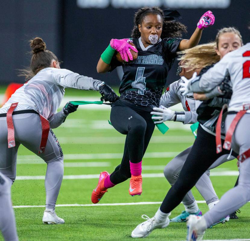 Palo Verde wide receiver Layla Roberts (4) has her flags pulled by Desert Oasis linebacker Bro ...