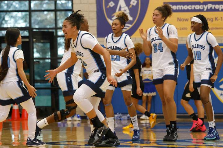 Centennial's players celebrate after defeating Democracy Prep 59-56 during their NIAA girls bas ...