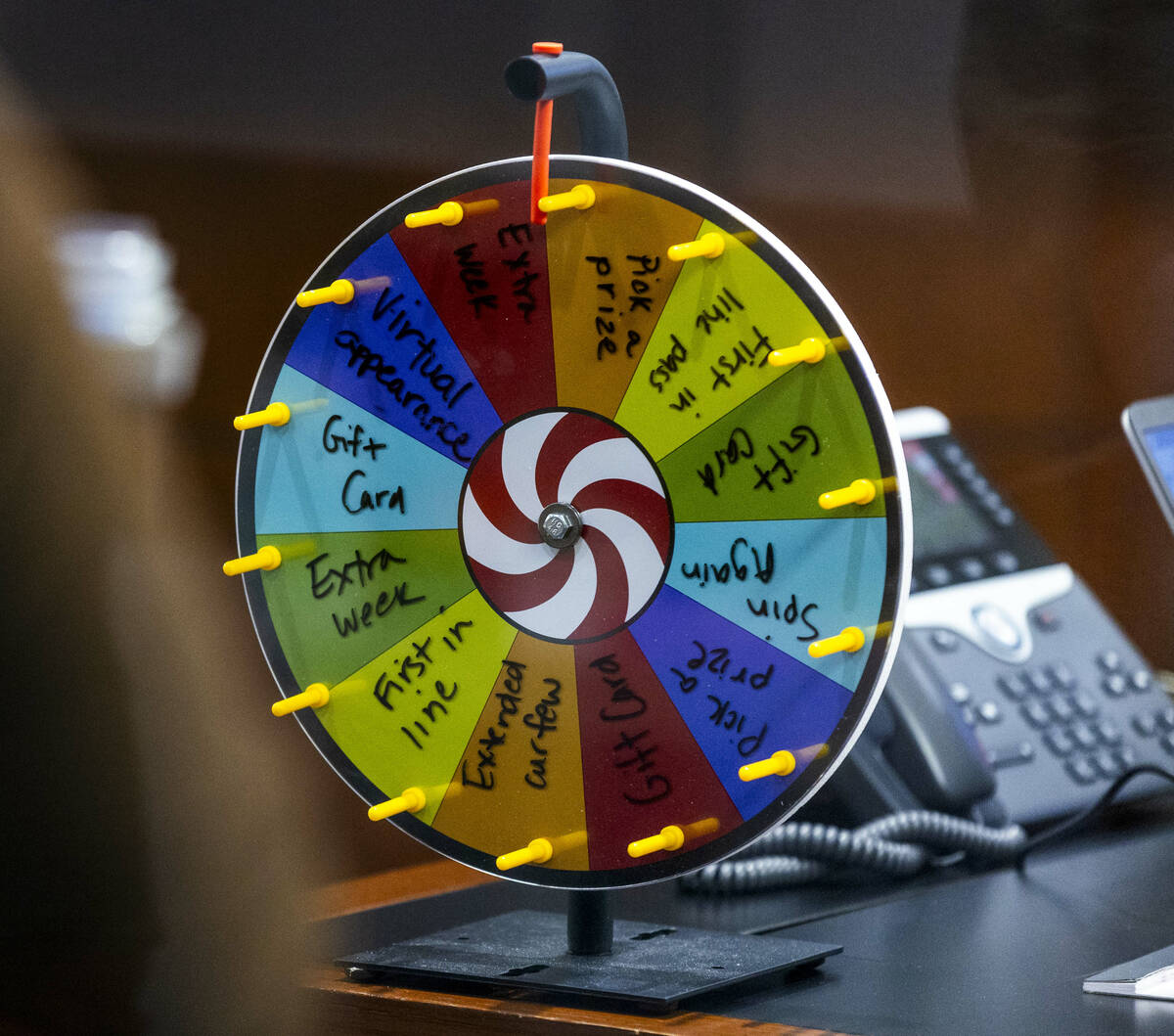 A prize wheel sits on a desk as Hearing Master Shannon Wittenberger presides over adult drug co ...