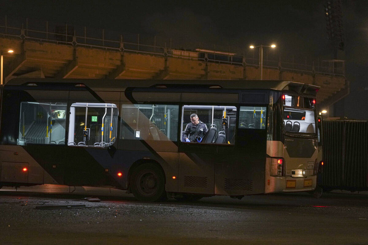 An Israeli police officer inspect the scene where police have reported a series of explosions o ...
