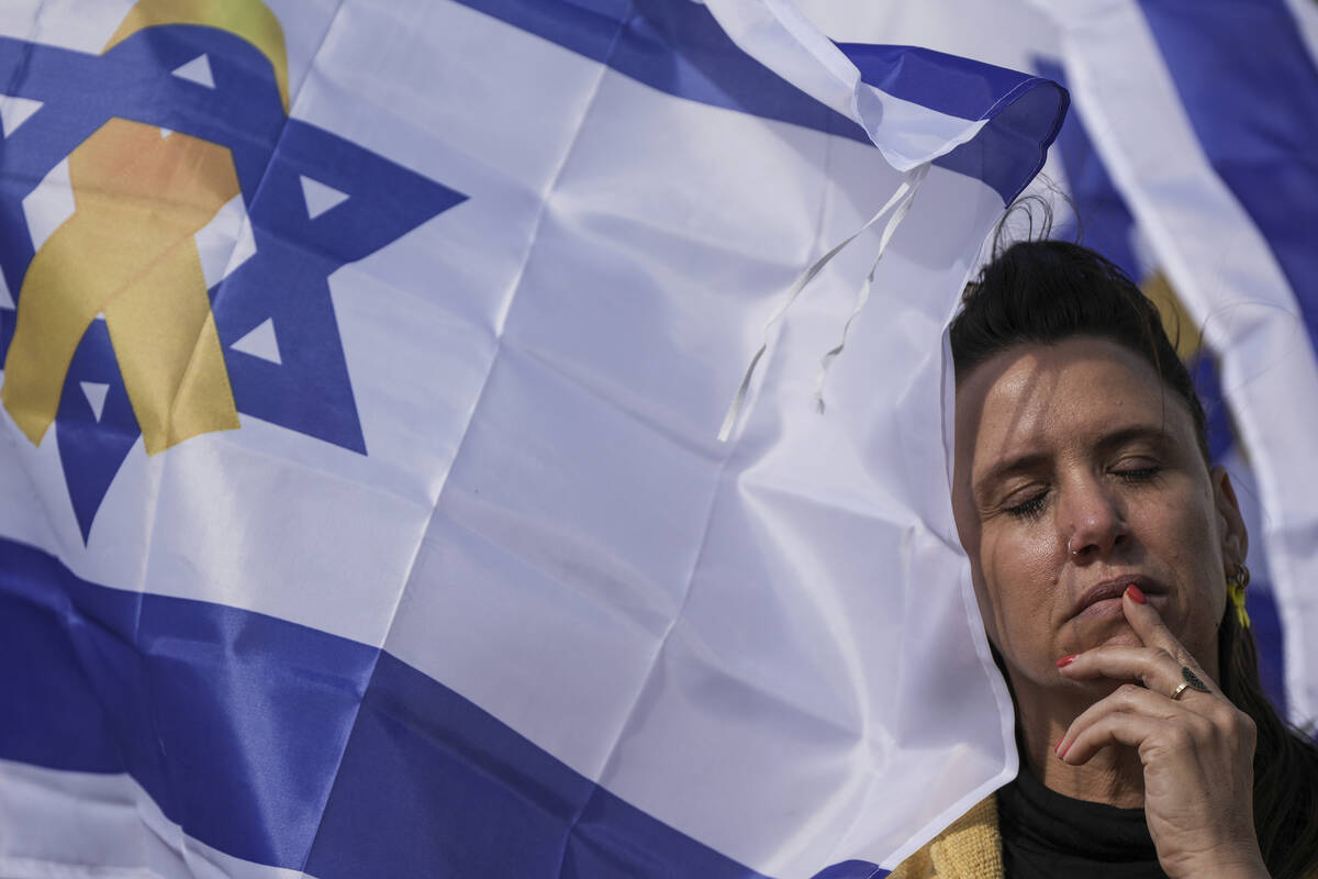 A woman reacts at the so-called 'Hostages Square' in Tel Aviv, Israel, Thursday, Feb. 20, 2025, ...