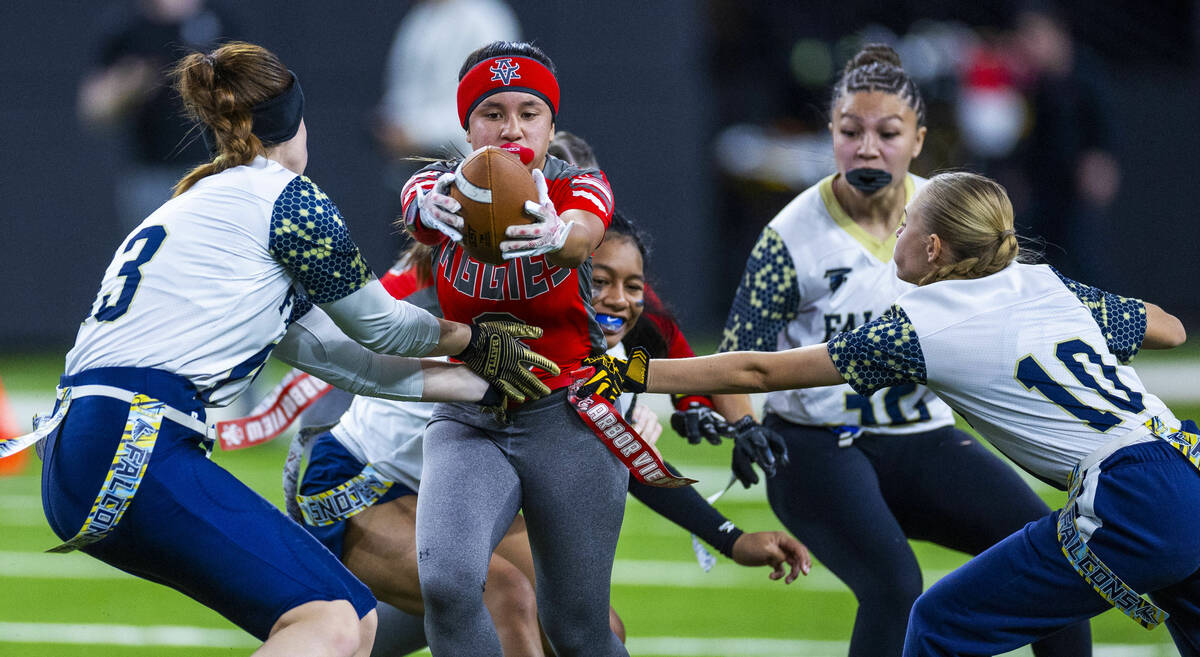 Arbor View running back Danielle Morales (3) is stopped by Foothill defensive backs Kaylie Hans ...