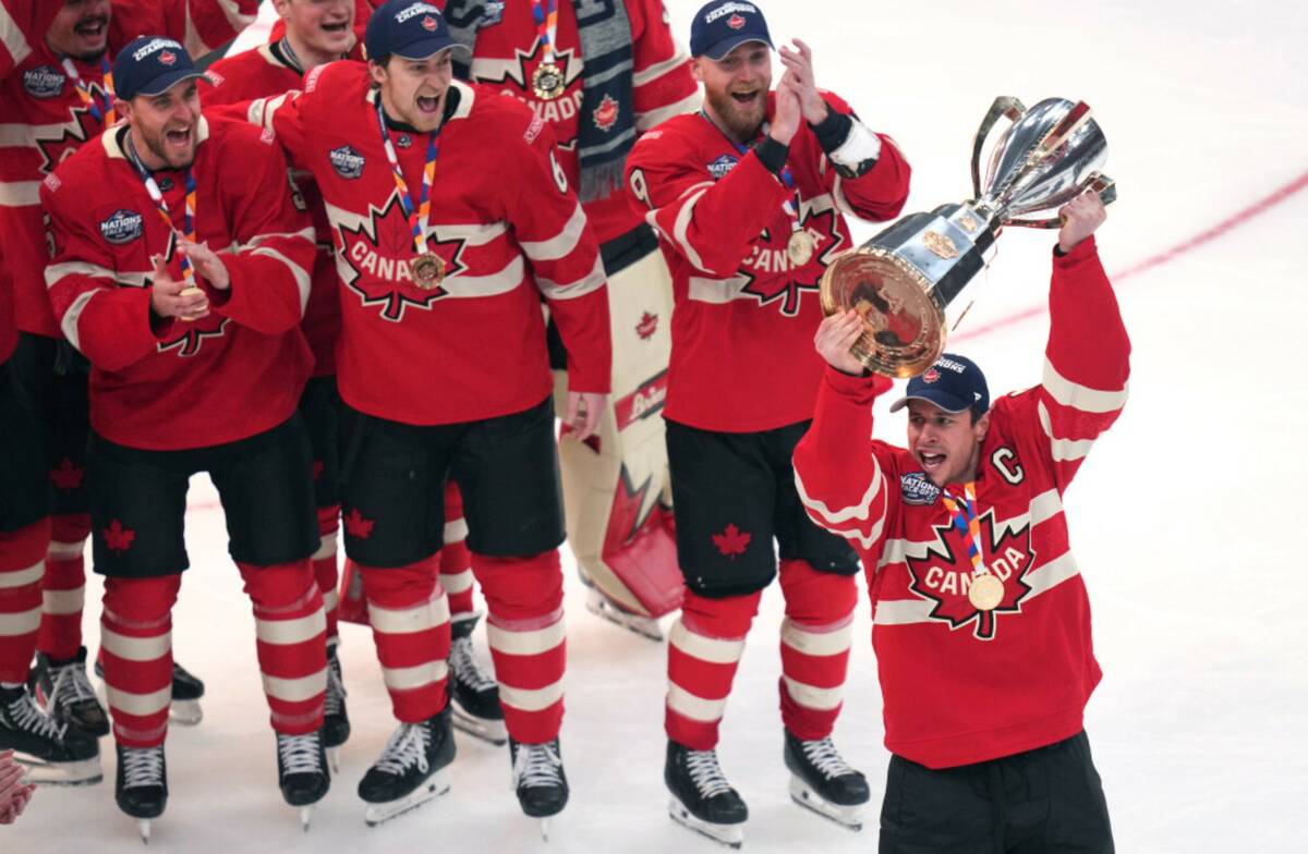 Canada captain Sidney Crosby, right, hoists the trophy after defeating the United States follow ...