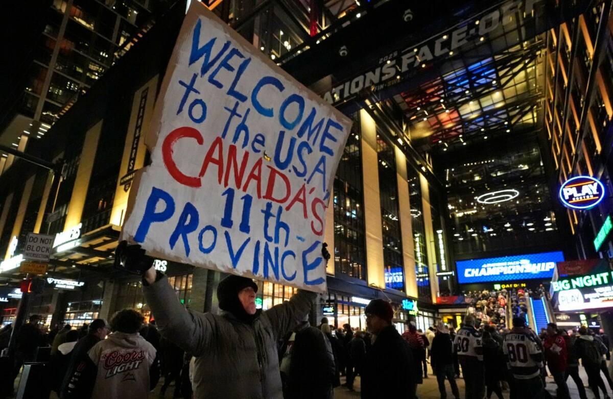 As fans enter the Boston Garden, a man holds a sign on the sidewalk prior to the 4 Nations Face ...
