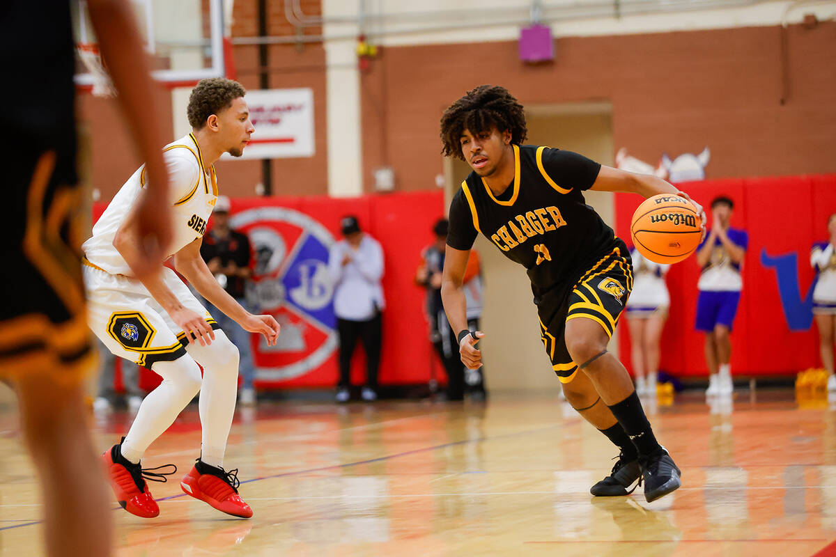 Clark point guard Elijah Coleman (11) dribbles the ball up the court during a Class 4A boys bas ...