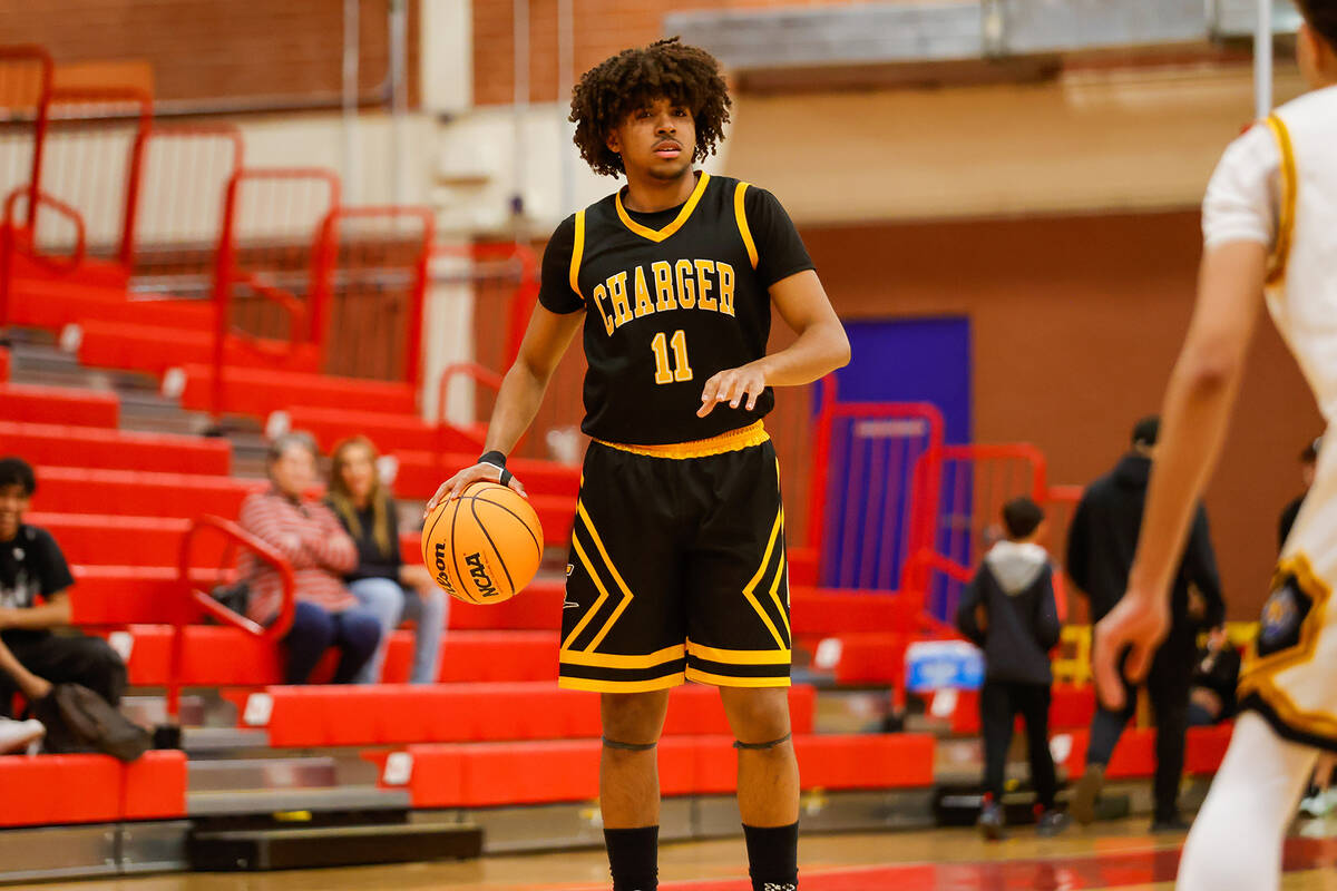 Clark point guard Elijah Coleman (11) scans the court during a Class 4A boys basketball state s ...