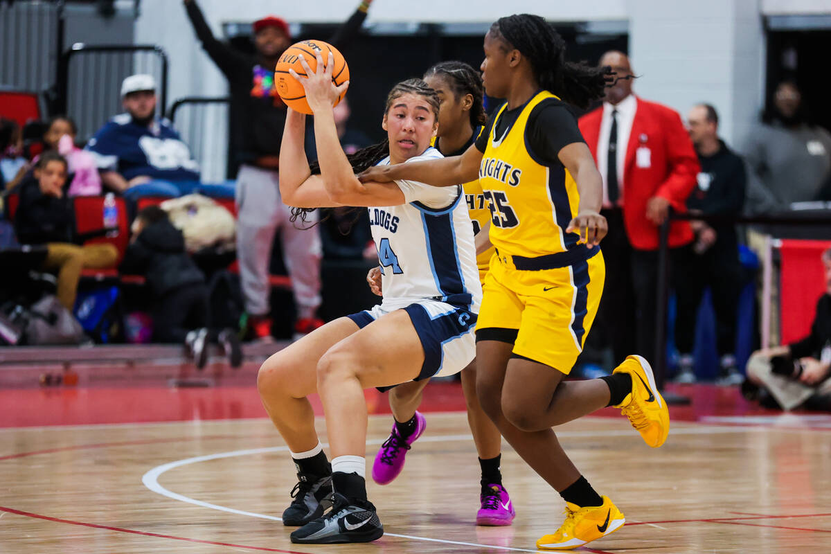 Centennial power forward Nation Williams (24) keeps the ball from Democracy Prep defense during ...
