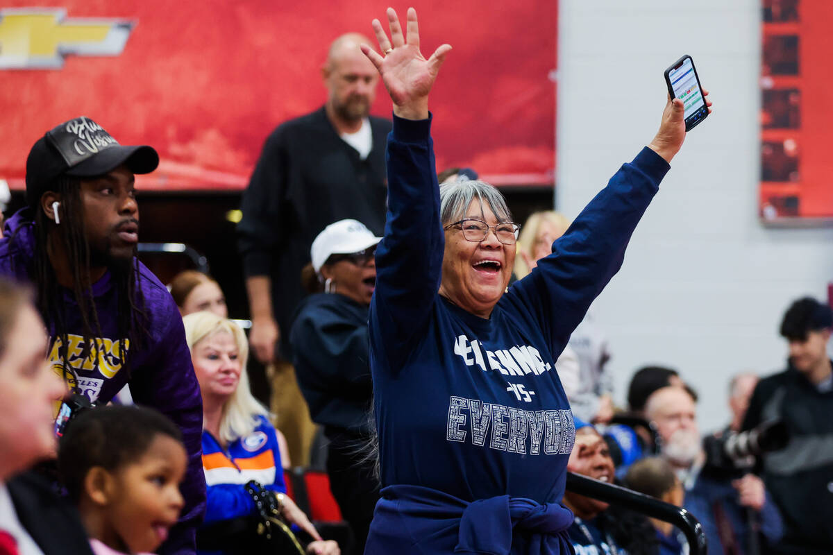 A Centennial fan cheers during a class 5A girls basketball state championship game between Cent ...