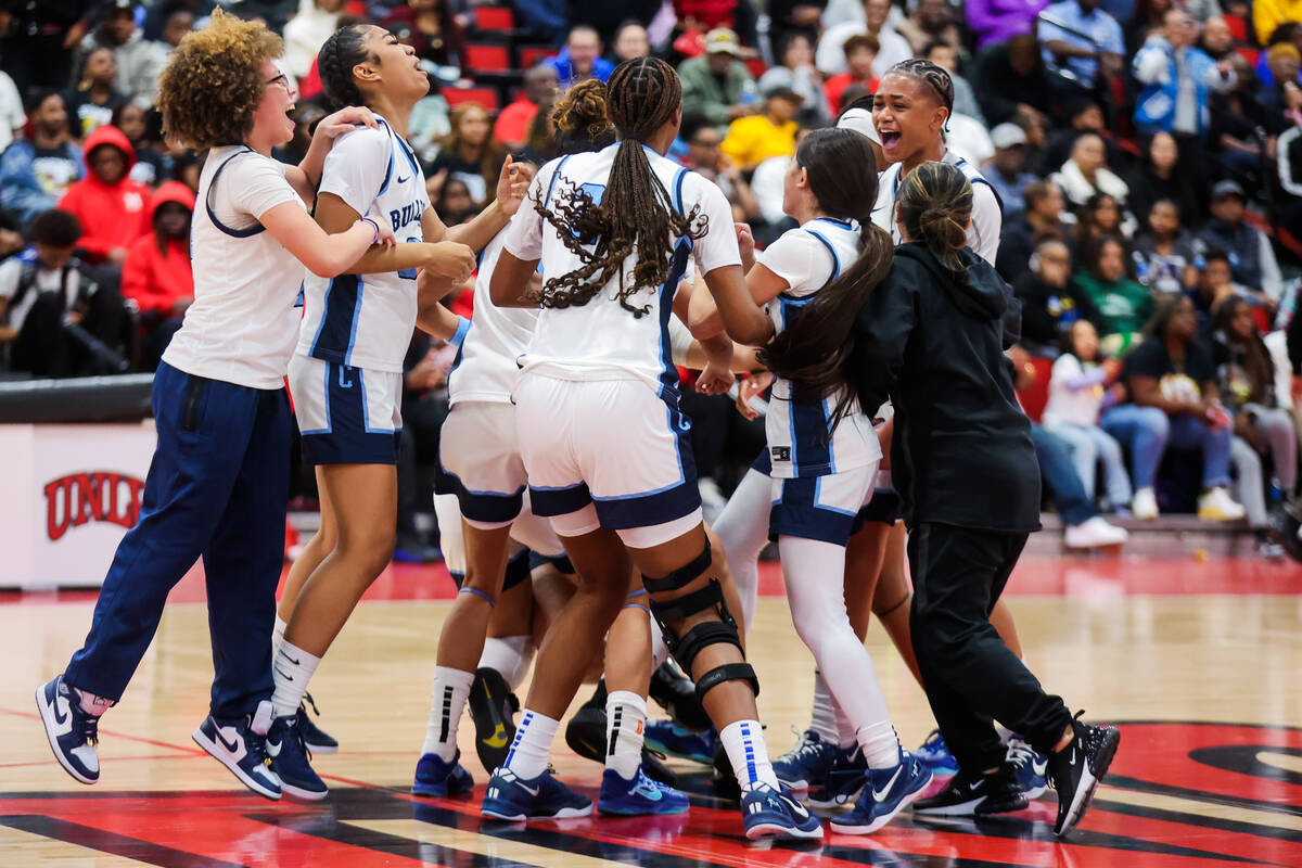 Centennial teammates celebrate winning a class 5A girls basketball state championship game betw ...