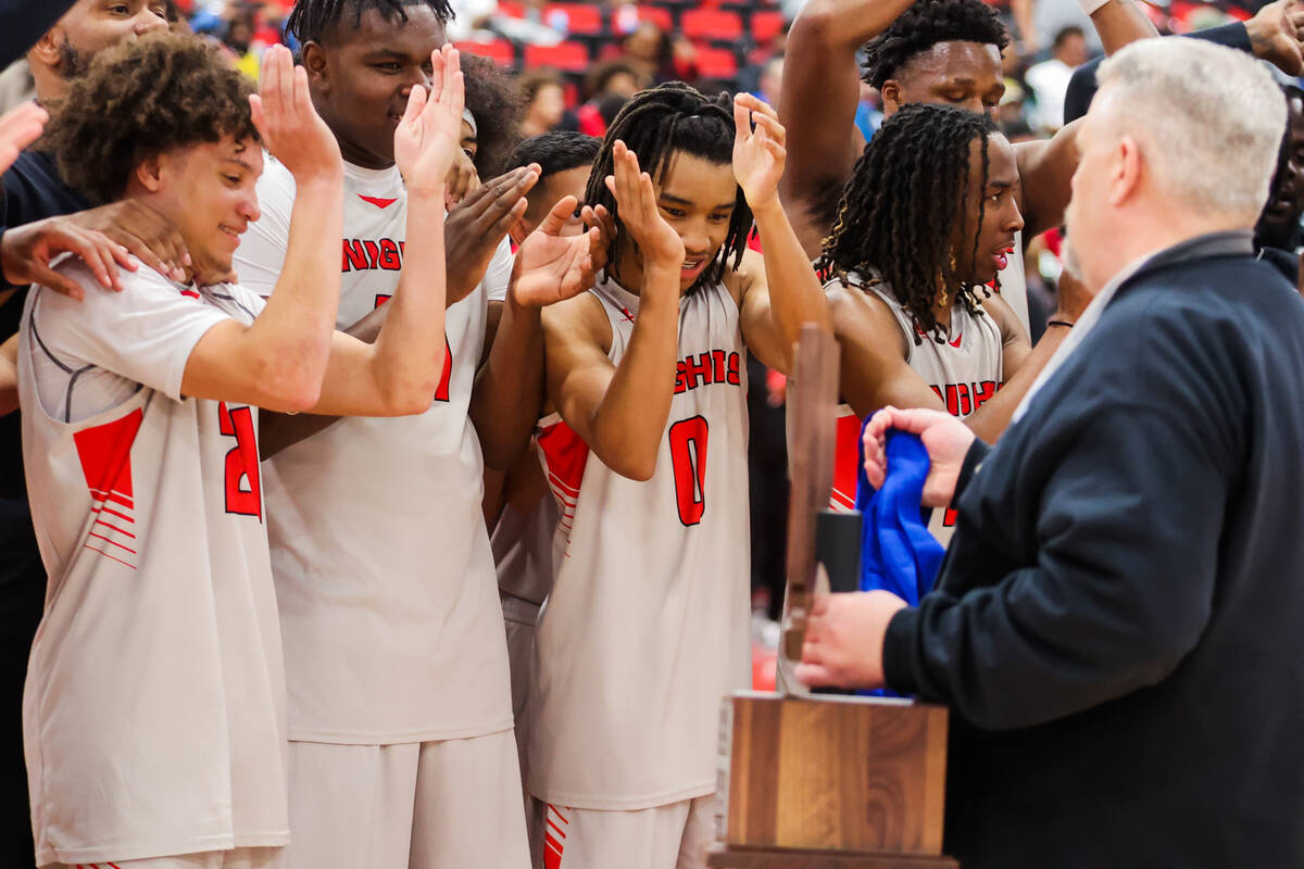 Mater East players celebrate winning a class 3A boys basketball state championship game between ...
