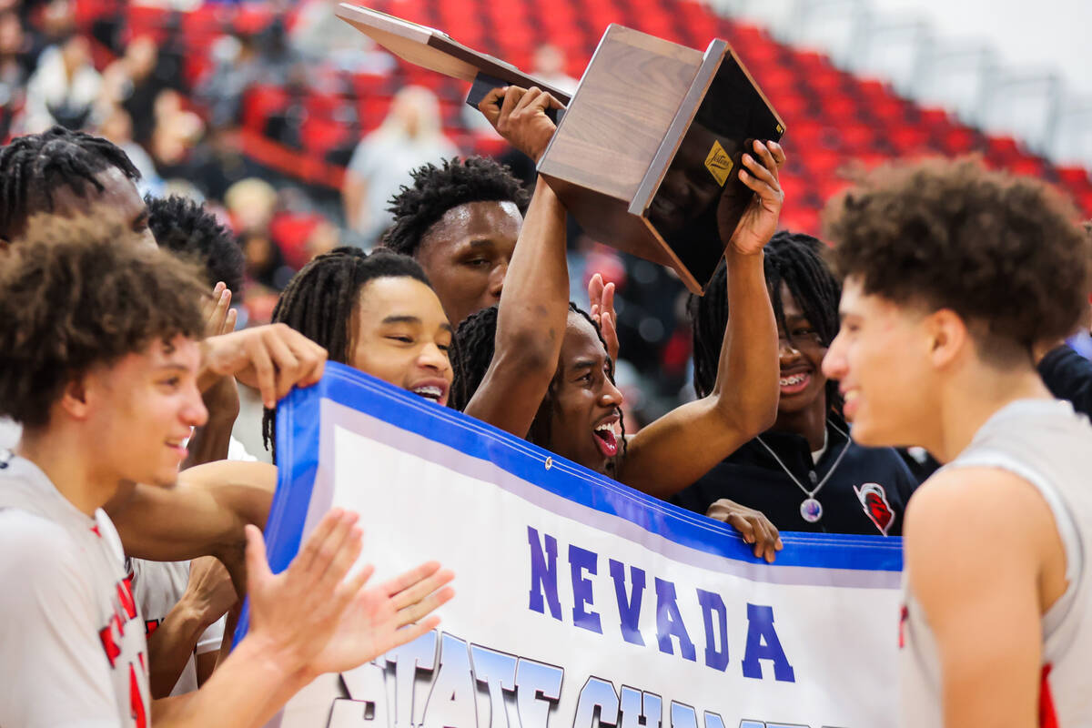 Mater East players celebrate winning a class 3A boys basketball state championship game between ...