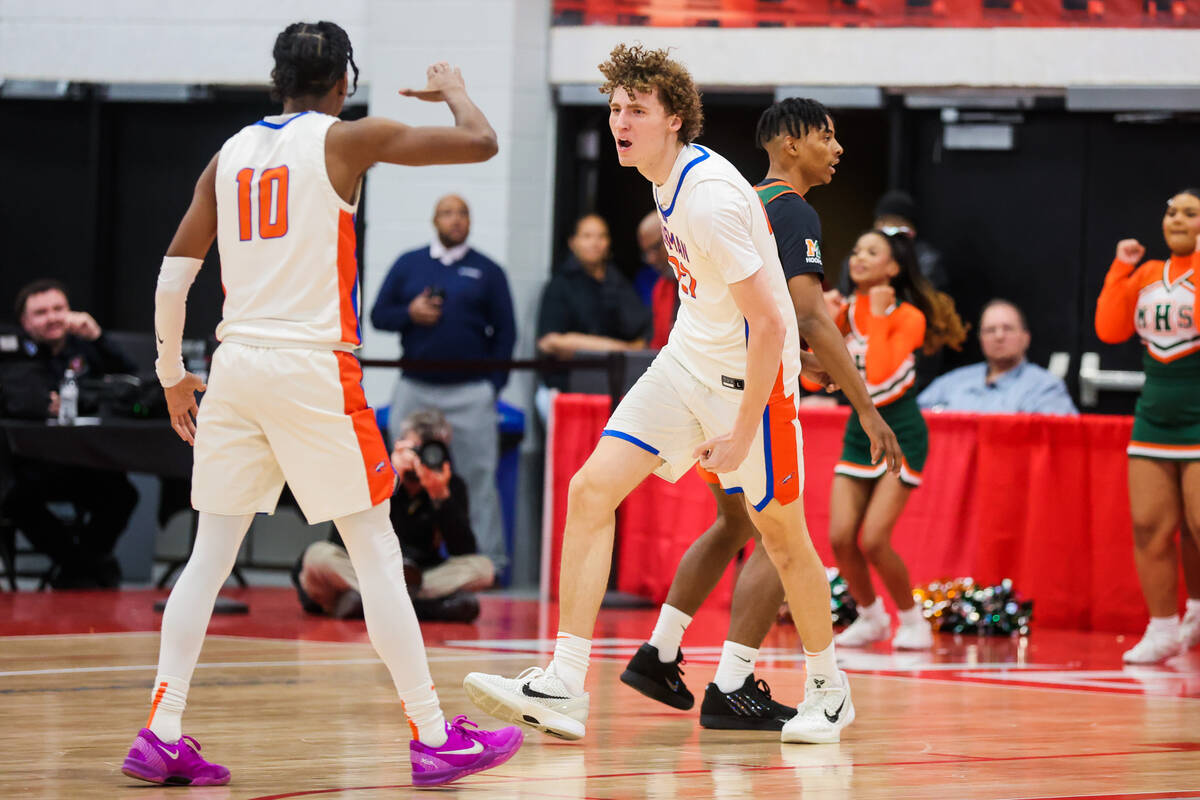 Bishop Gorman center Chris Baudreau (21) celebrates a basket during a class 5A boys basketball ...