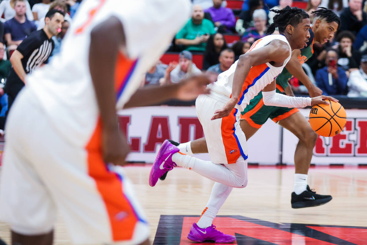 Bishop Gorman guard Nick Jefferson, middle, rushes the ball down the court during a class 5A bo ...