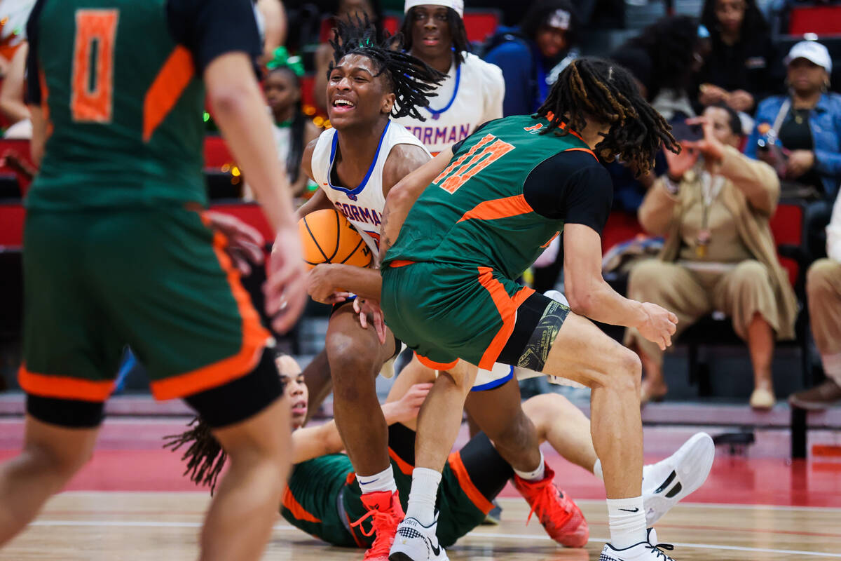Bishop Gorman wing Jett Washington (2) struggles to move the ball against Mojave defense during ...
