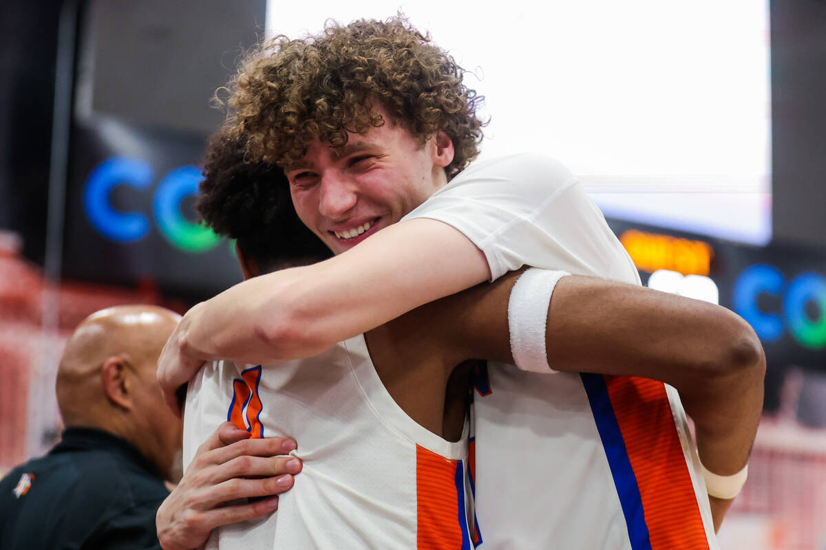 Bishop Gorman teammates celebrate winning a class 5A boys basketball state championship game be ...