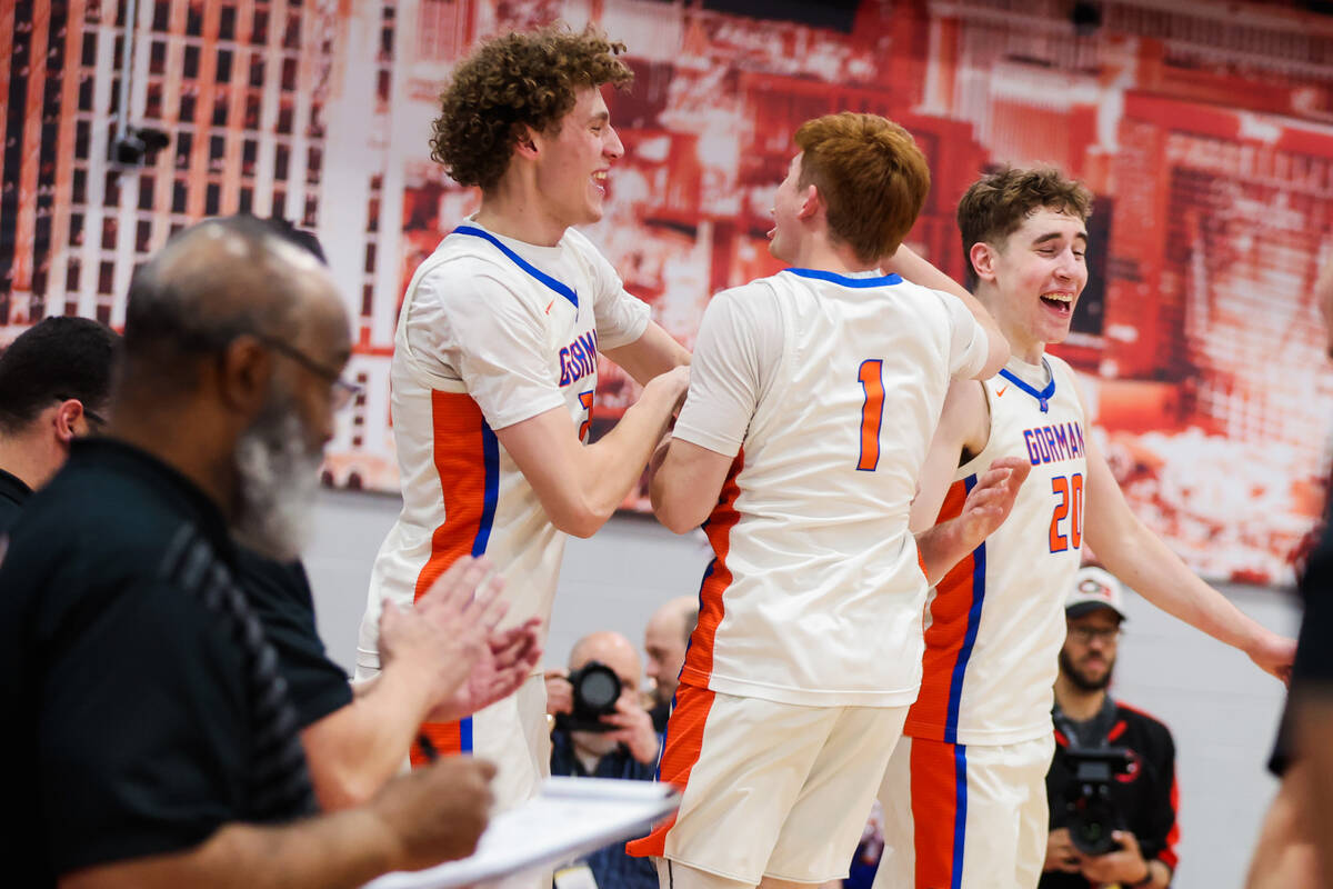 Bishop Gorman teammates celebrate winning a class 5A boys basketball state championship game be ...