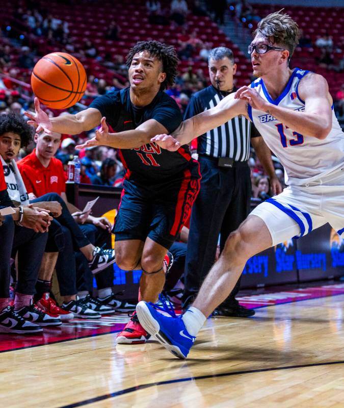 UNLV guard Dedan Thomas Jr. (11) looks to secure a loose ball against Boise State Broncos forwa ...