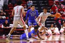 UNLV guard Dedan Thomas Jr. (11) looks to pass the ball as Air Force guard Byron Brown (11) get ...