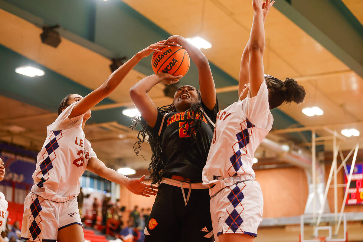 Losee forward Tia Cleveland (21) is blocked by Legacy defenders during a Class 4A girls basketb ...