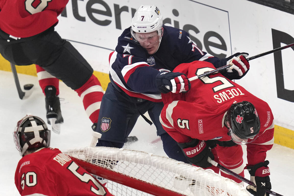 United States' Brady Tkachuk checks Canada's Devon Toews (5) during the first period of the 4 N ...