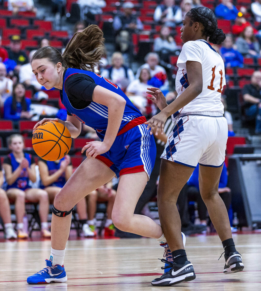 Reno forward Eva Houston (20) navigates around Legacy guard Deshaya Hart (11) during the first ...