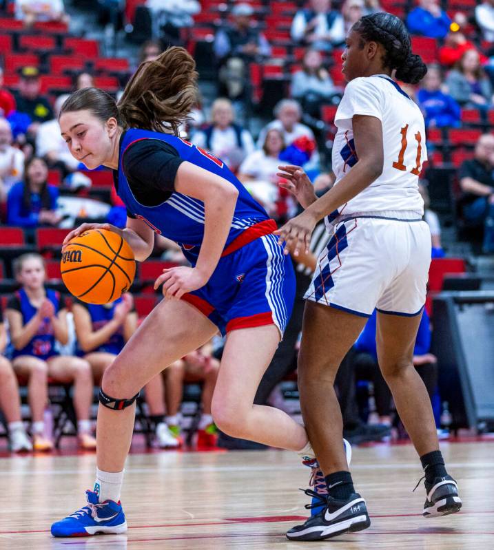 Reno forward Eva Houston (20) navigates around Legacy guard Deshaya Hart (11) during the first ...