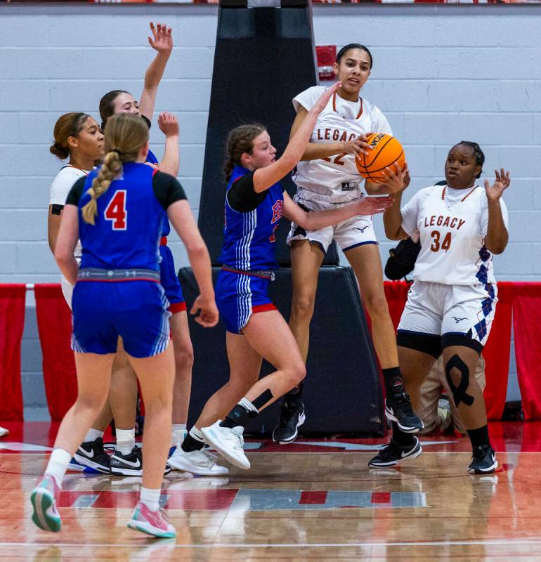Legacy forward Trista Mabry (22) pulls down a rebound over Reno forward Natalia Schettler (23) ...