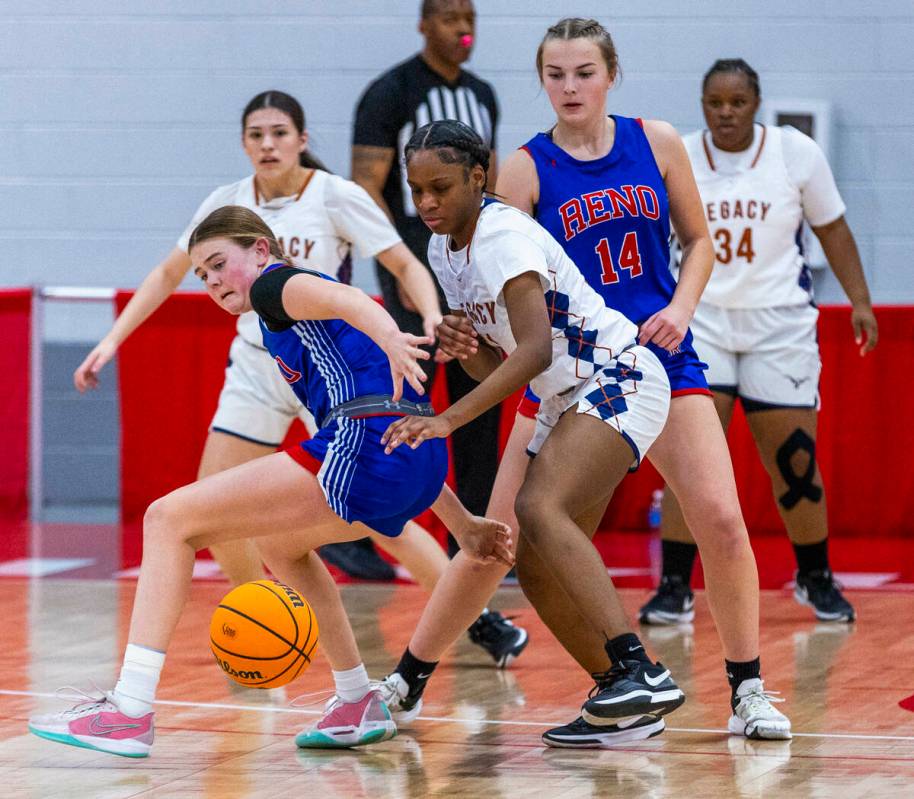 Reno guard Brookesly Wilson (4) has the ball picked away by Legacy guard Deshaya Hart (11) duri ...