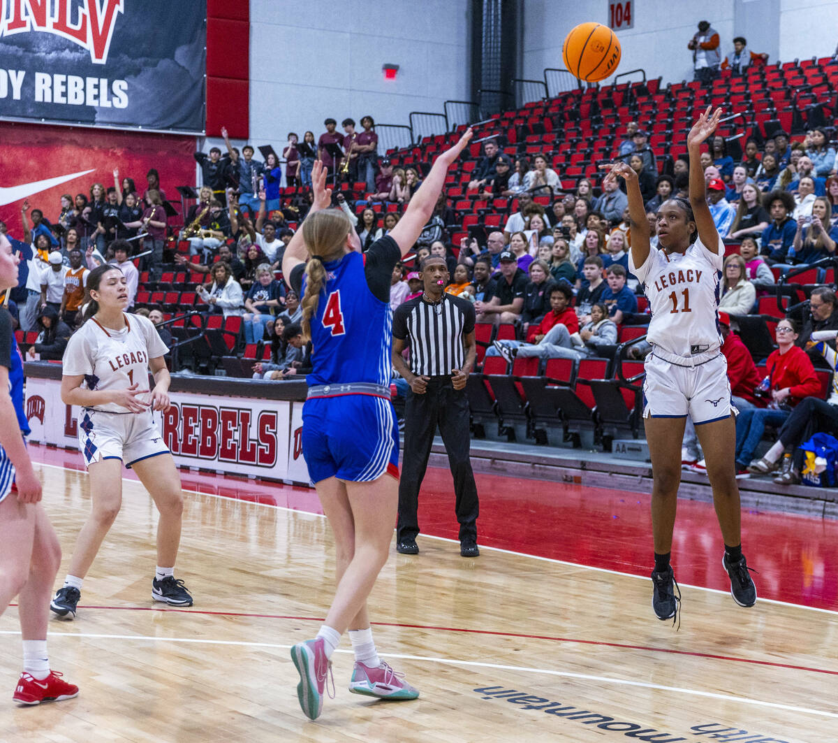 Legacy guard Deshaya Hart (11) shoots over Reno guard Brookesly Wilson (4) during the first hal ...