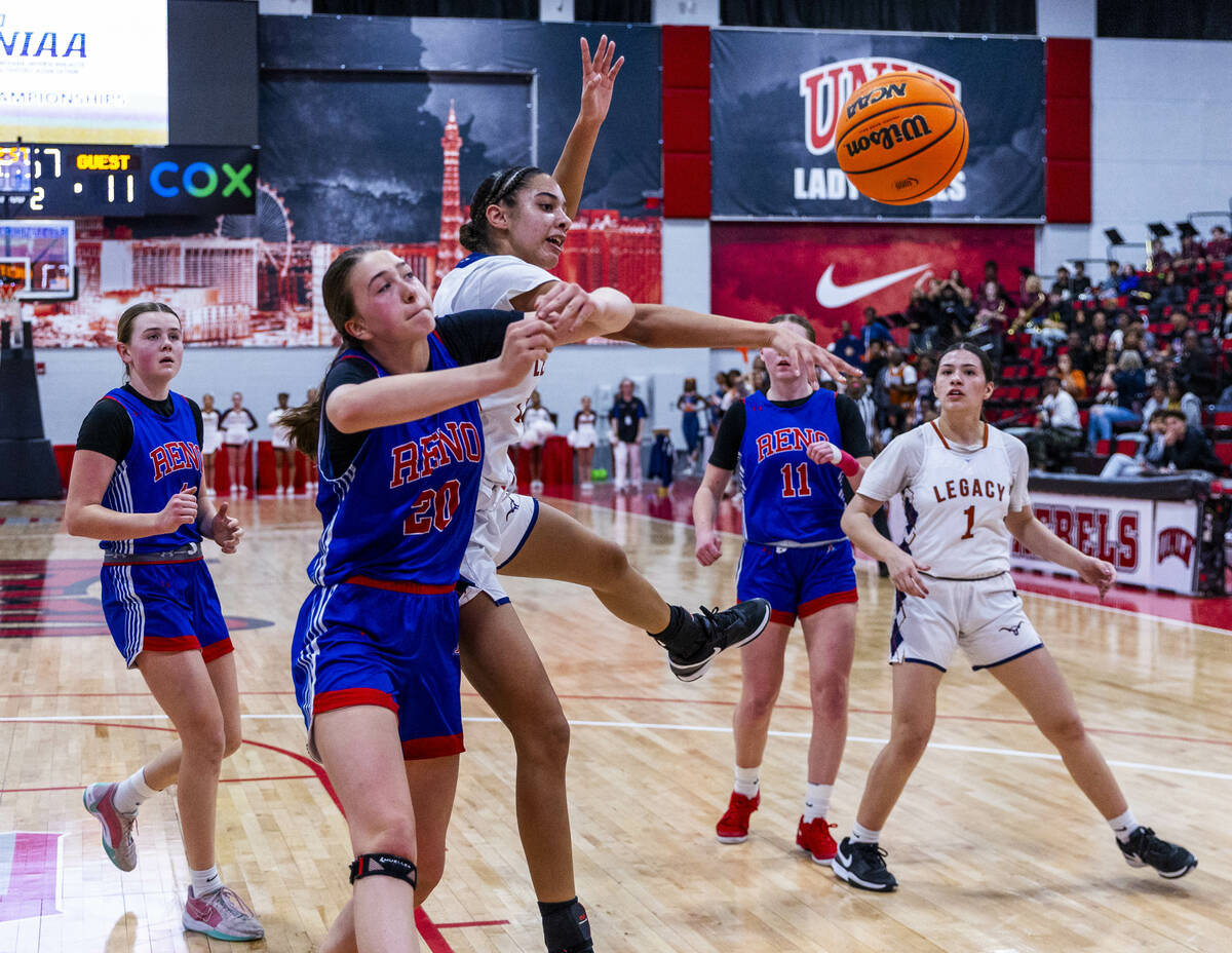 Reno forward Eva Houston (20) has the ball poked away by Legacy forward Trista Mabry (22) durin ...