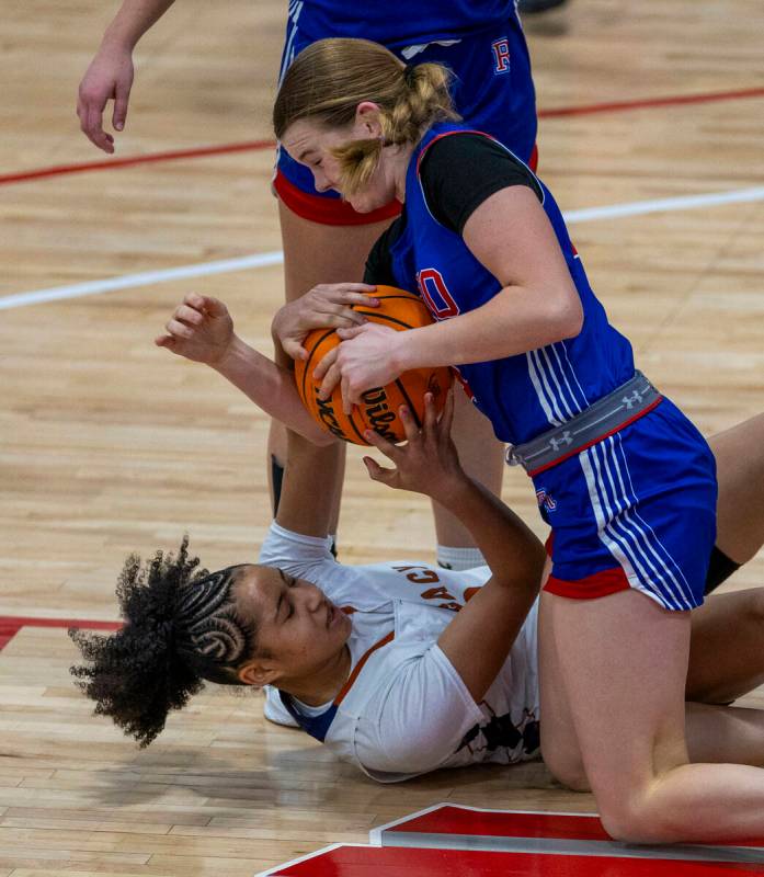 Legacy guard Laila Gines (3) battles for a loose ball with Reno guard Brookesly Wilson (4) Reno ...