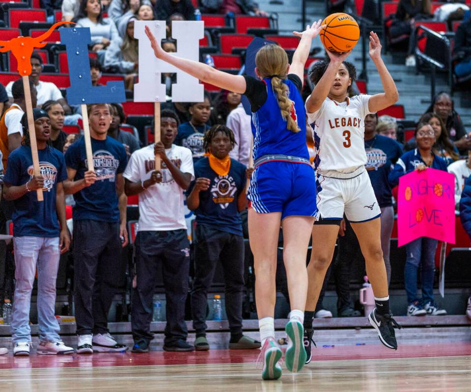 Legacy guard Laila Gines (3) shoots a three-point basket over Reno guard Brookesly Wilson (4) R ...