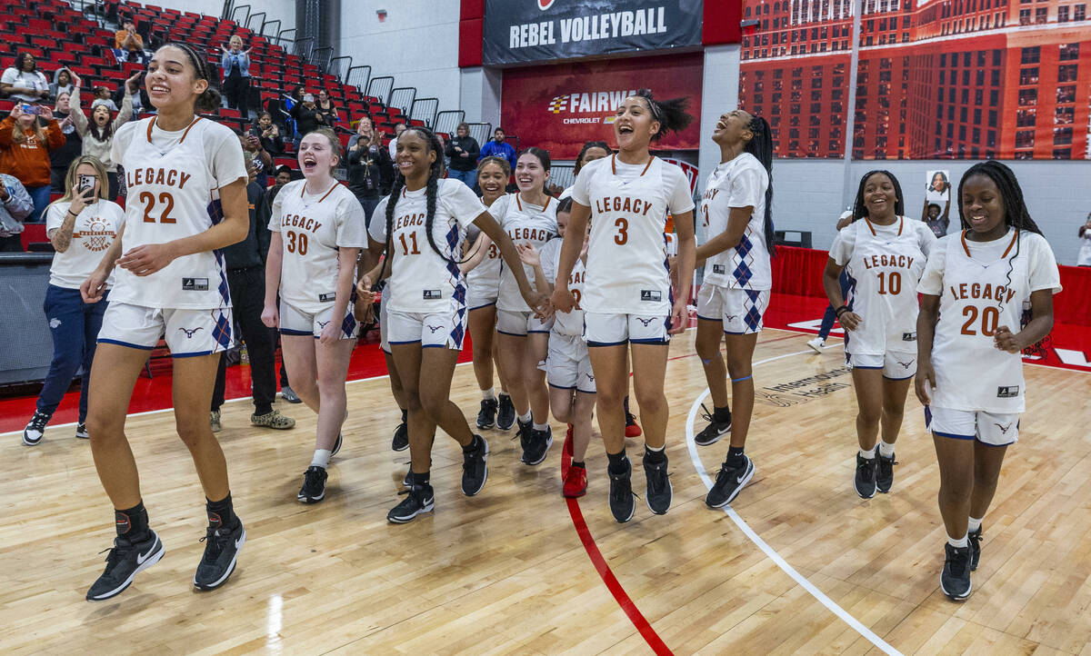 Legacy teammates celebrate their win over Reno during their 4A girls basketball state champions ...