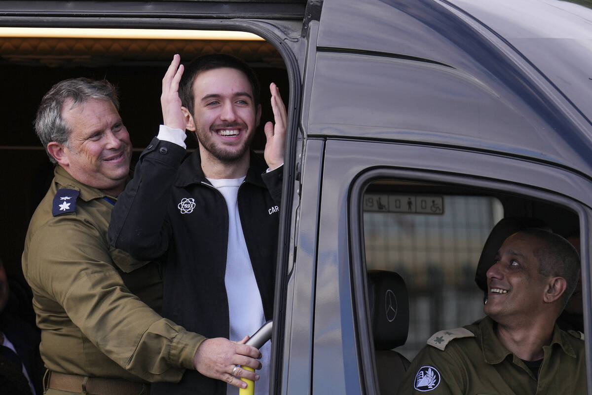 Freed Israeli hostage Omer Shem Tov looks on from a van as he arrives at Beilinson hospital in ...