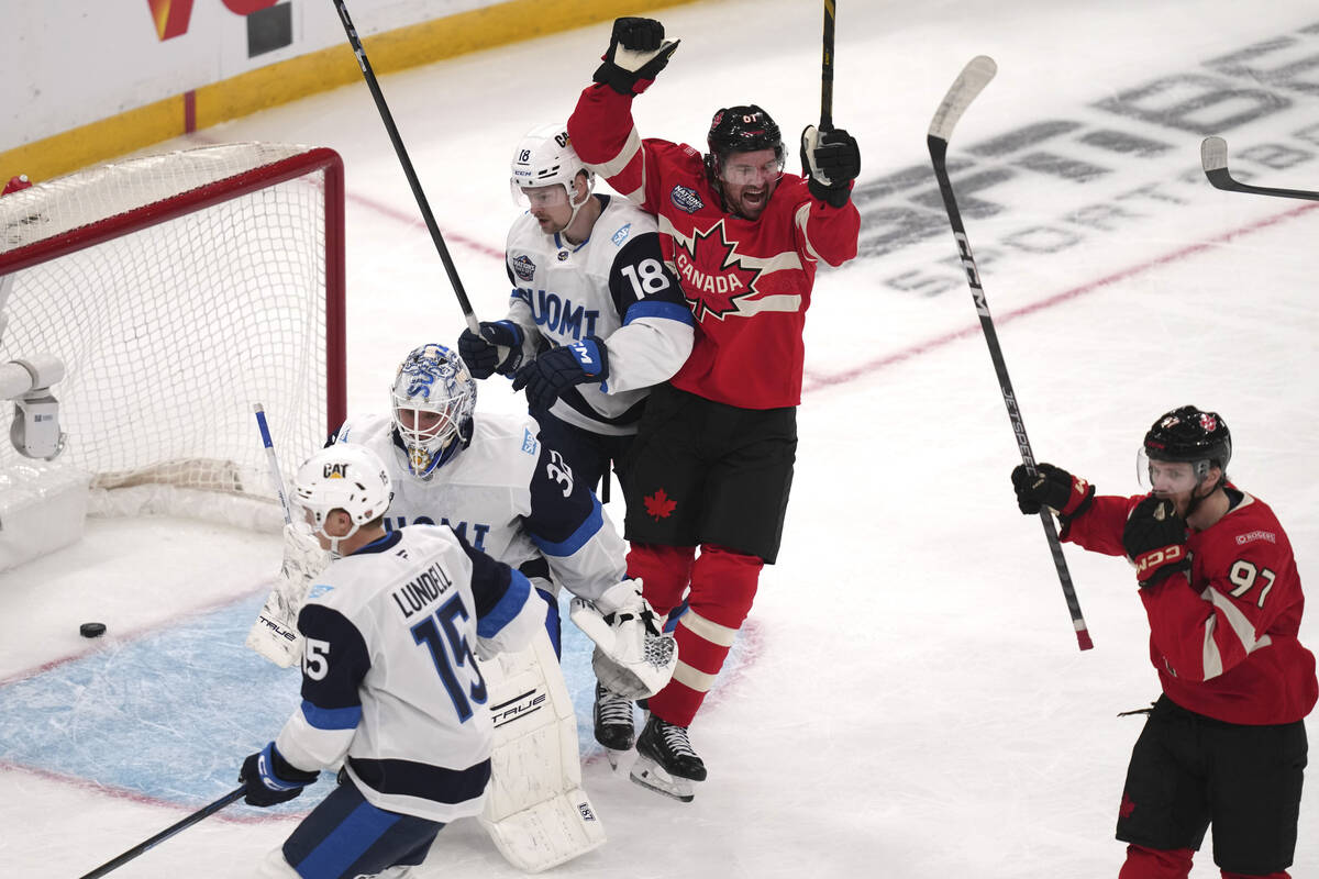 Canada's Mark Stone, center, celebrates after a goal by Connor McDavid during first period of a ...