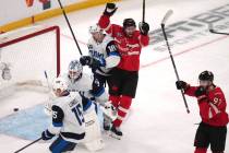 Canada's Mark Stone, center, celebrates after a goal by Connor McDavid during first period of a ...